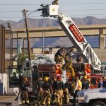 image of firefighters, a crane, and a fire truck