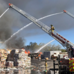 multiple cranes putting out an outdoor fire