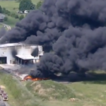 aerial shot of black smoke coming from a burning building