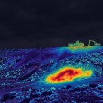 A thermal image of a landfill with a red spot showing a subsurface hotspot