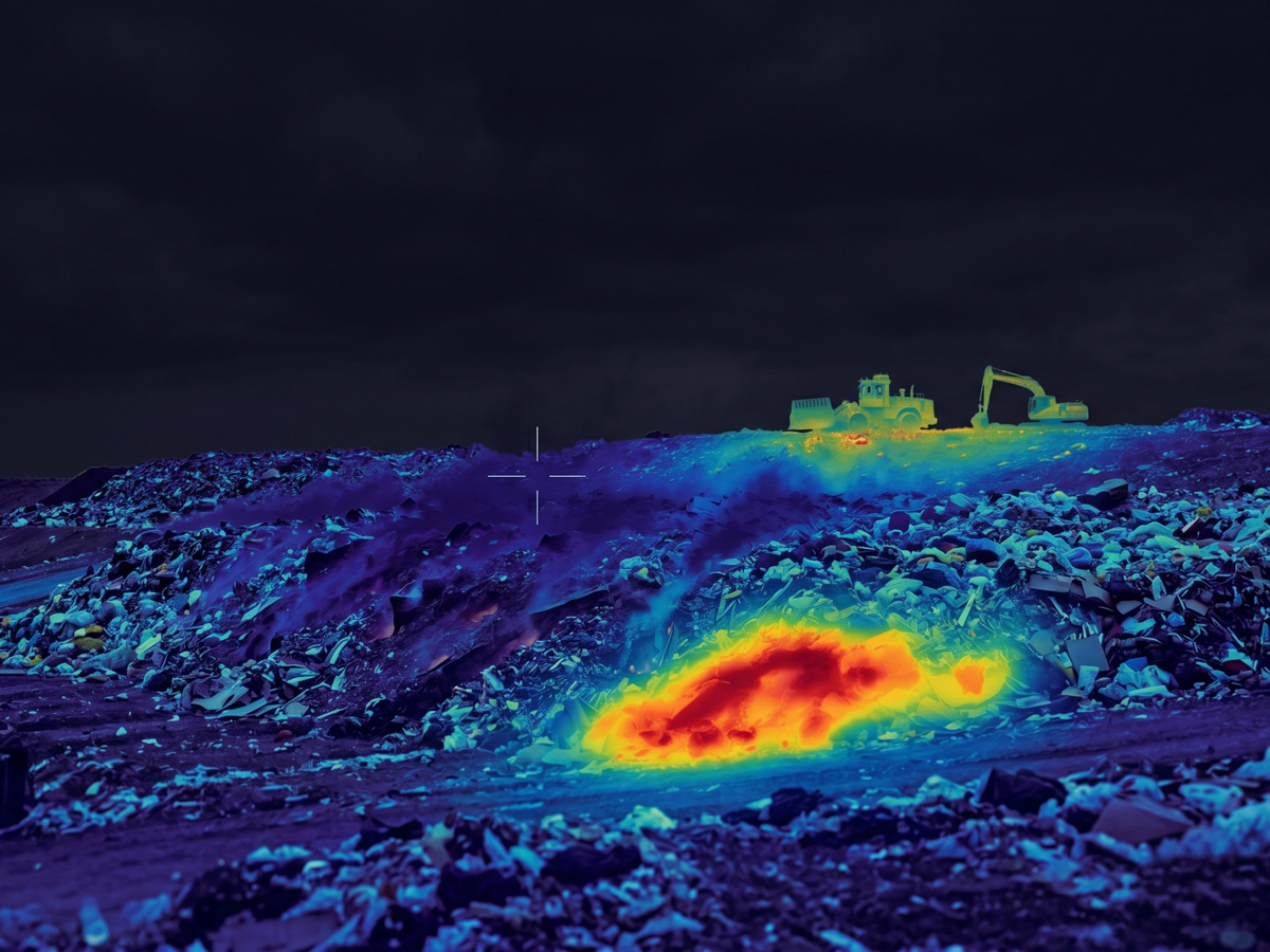 A thermal image of a landfill with a red spot showing a subsurface hotspot