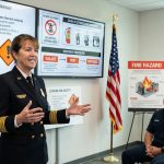 Fire chief presents lithium-ion battery thermal runaway and fire response procedures to firefighters during a safety training session.